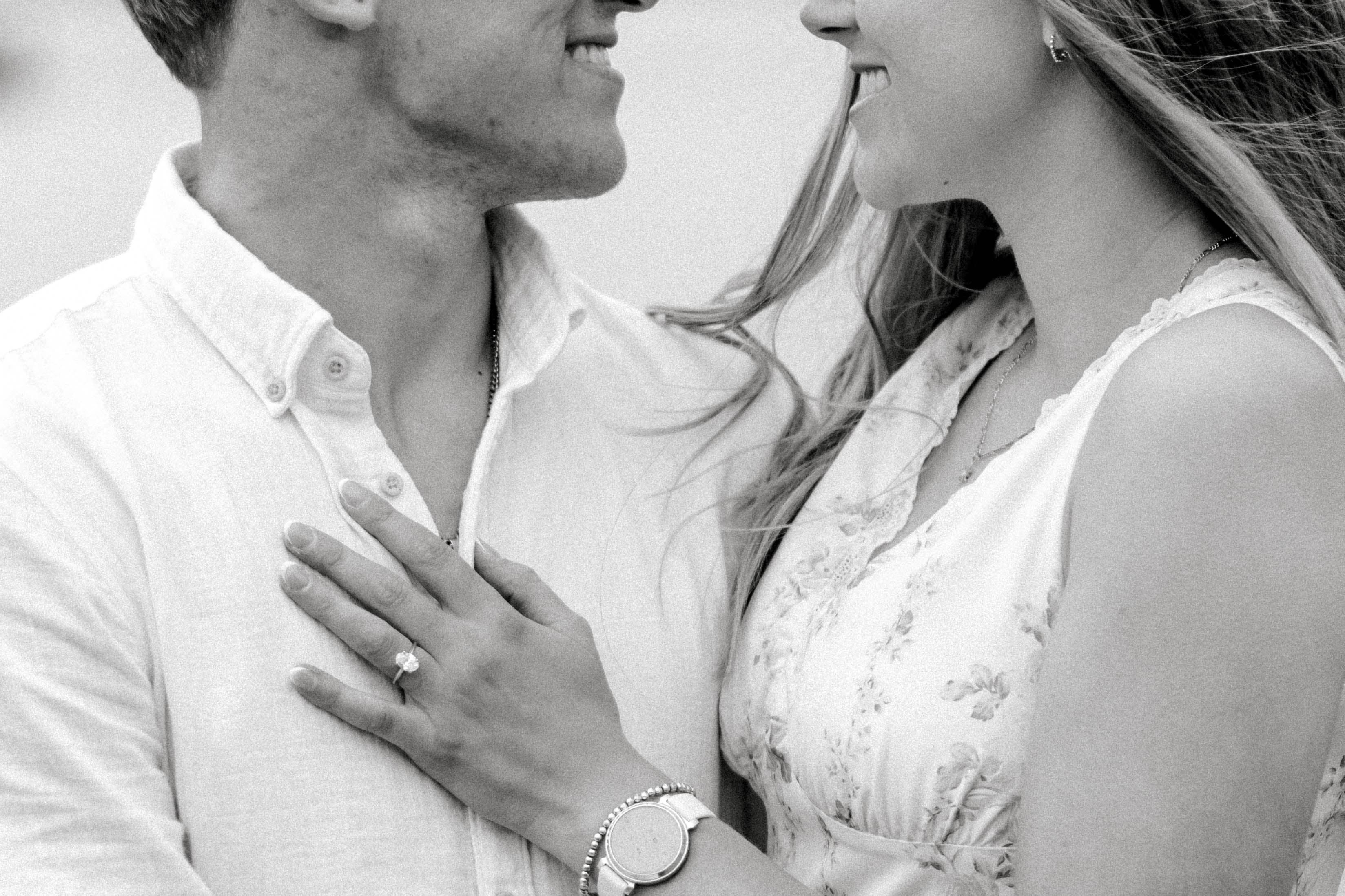Close-up of Alyssa's engagement ring as she and Tysen smile together