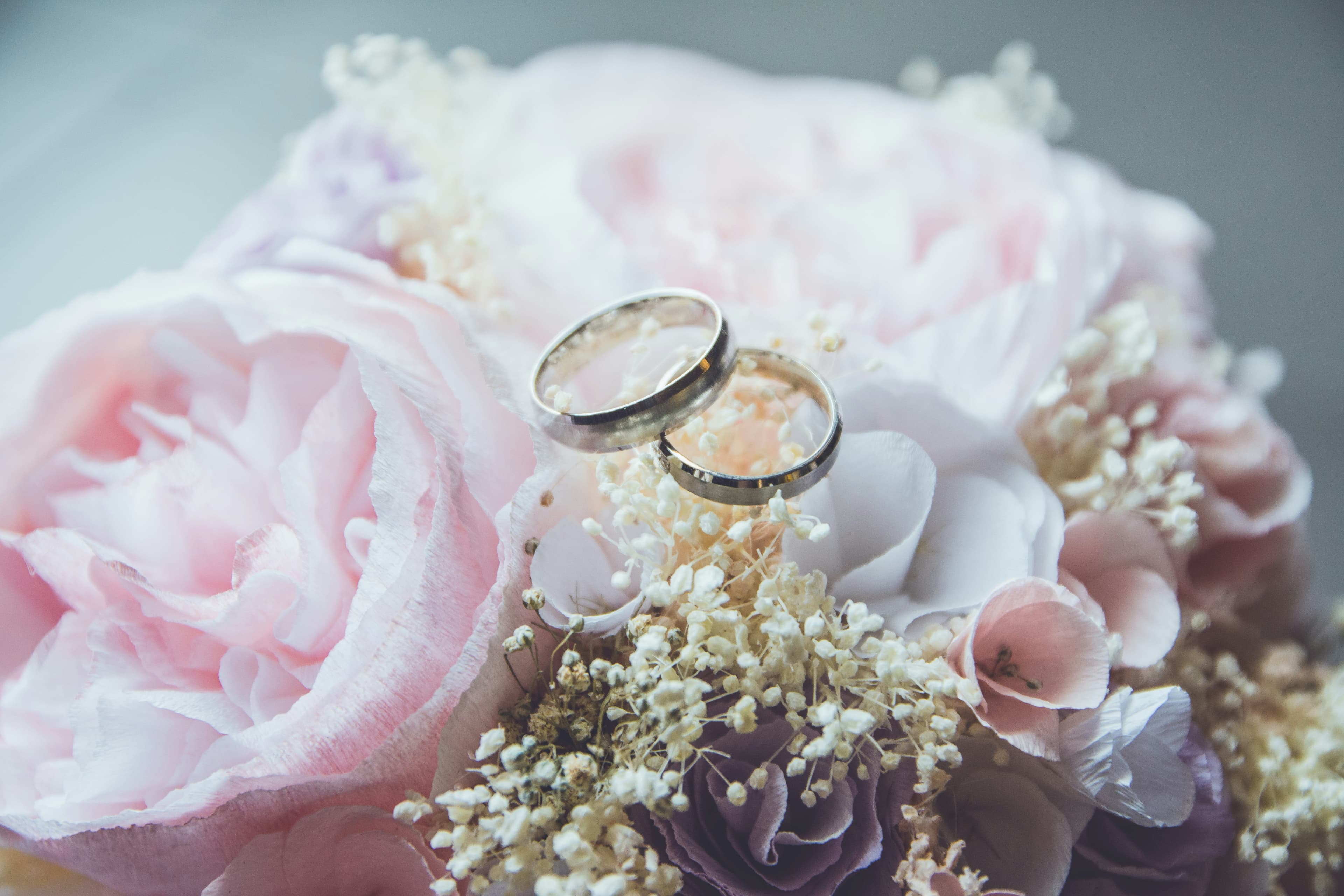 Placeholder photograph of wedding bands arranged on flowers