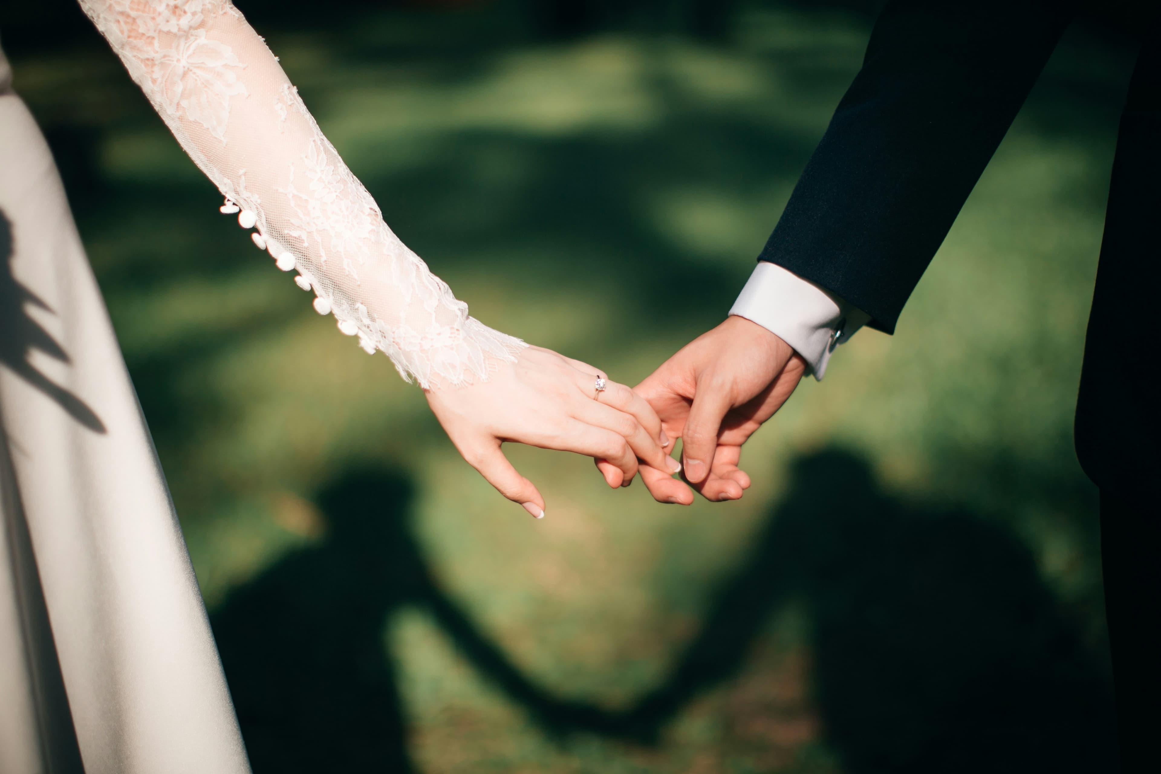 Placeholder photograph of a couple holding hands