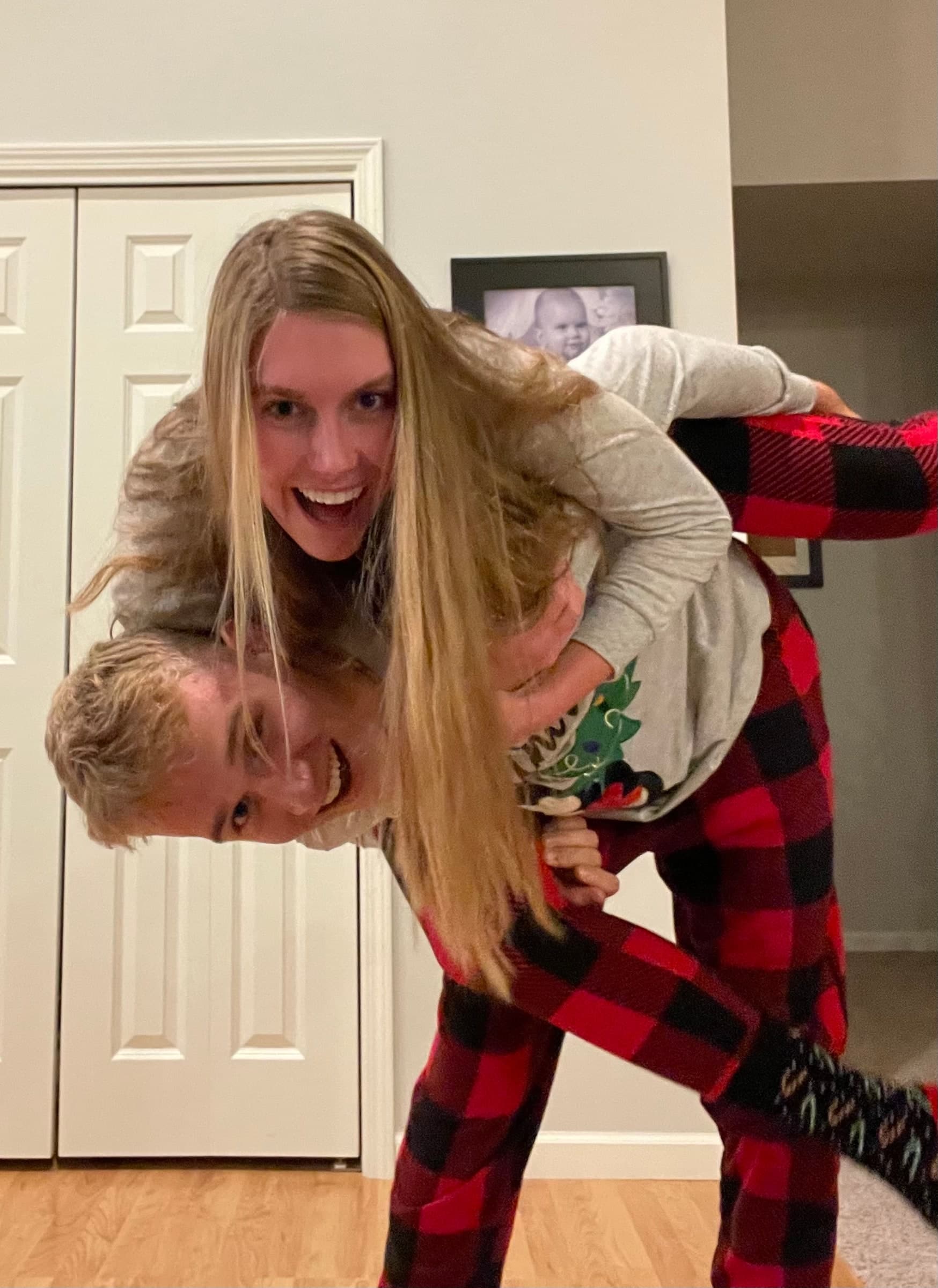 Alyssa on Tysen’s back as they laugh together in a kitchen