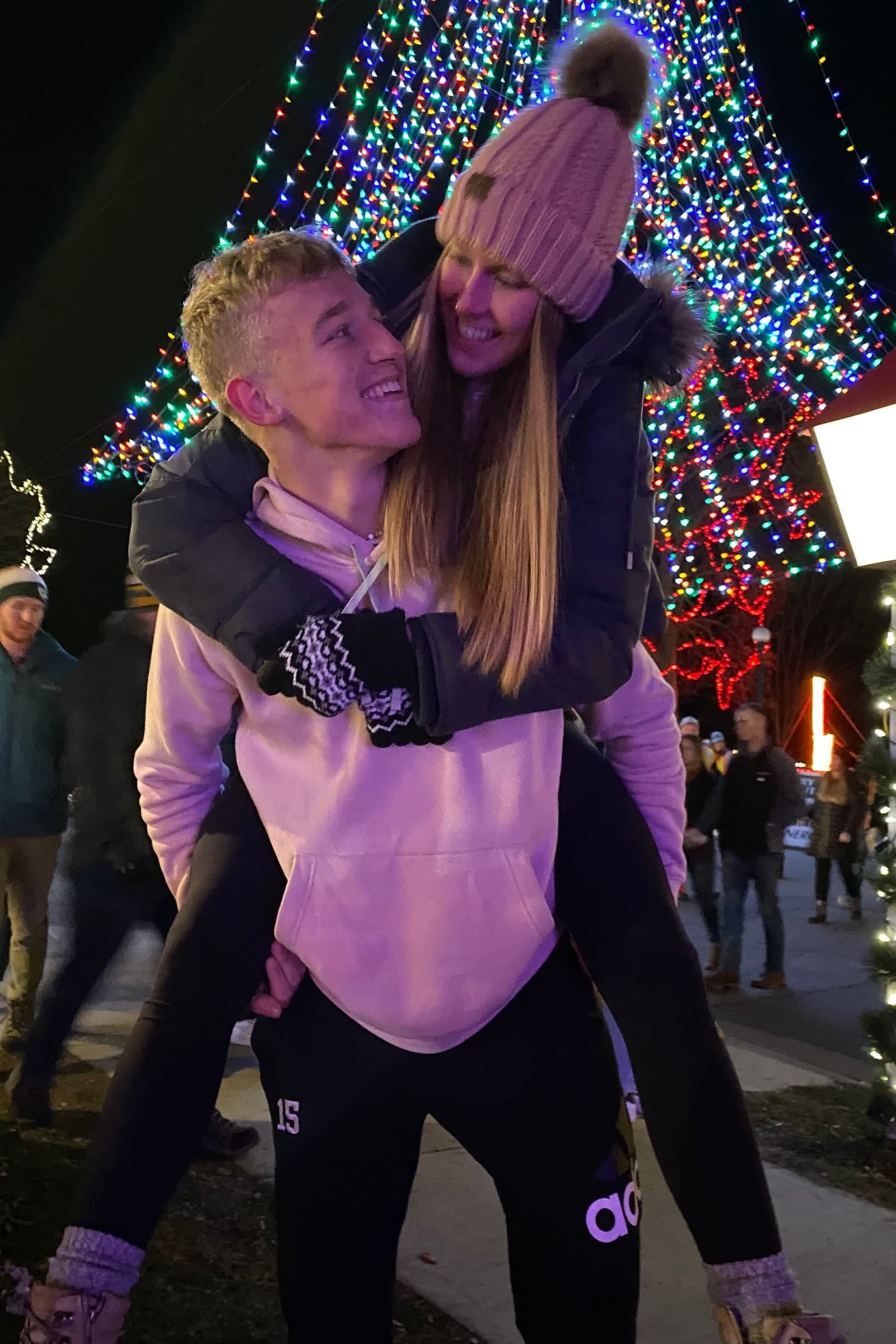 Alyssa and Tysen smiling beneath the colorful Rotary Lights